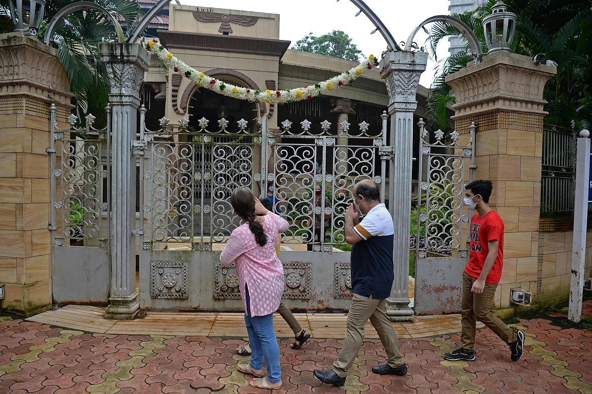 A Parsi family pays respect outside the fire temple on the occasion of Parsi New Year in Mumbai on August 16, 2021.