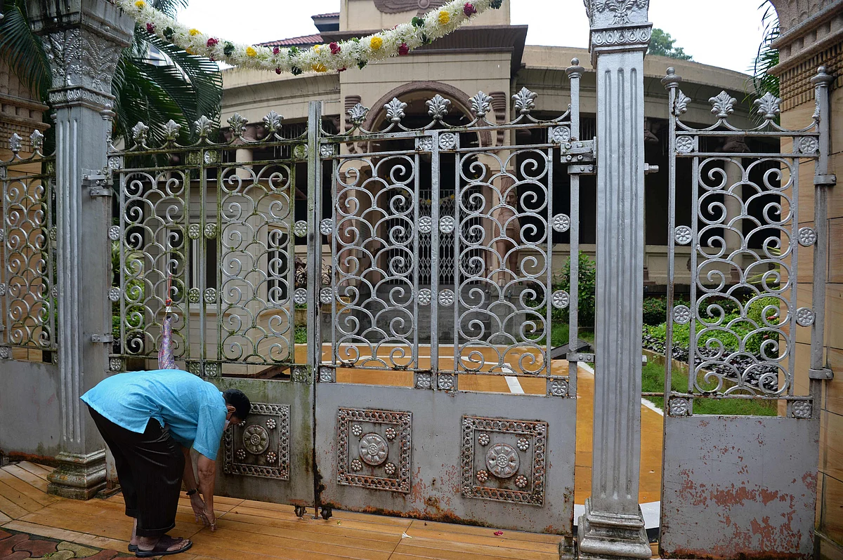A man pays respect outside the fire temple on the occasion of Parsi New Year in Mumbai on August 16, 2021.