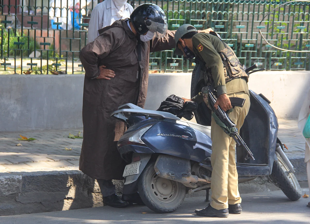 A policeman checks a scooter during a shutdown on the second anniversary of abrogation of Article 370 & 35A in Srinagar, Jammu & Kashmir on August 5, 2021.