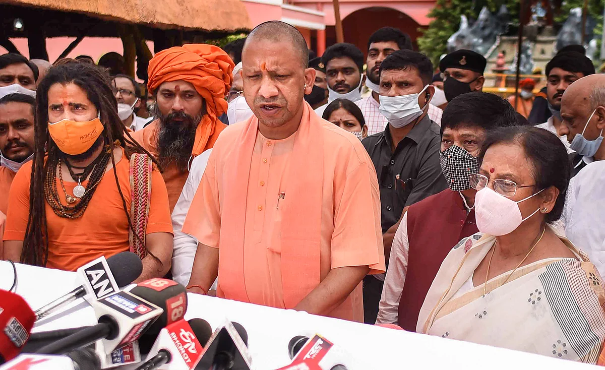 UP CM Yogi Adityanath talks to the media as he arrives to pay tribute to Akhil Bharatiya Akhara Parishad President Mahant Narendra Giri Maharaj, who was found dead at the Baghambari Gaddi Math in mysterious conditions, in Prayagraj, Tuesday, Sept. 21, 2021.