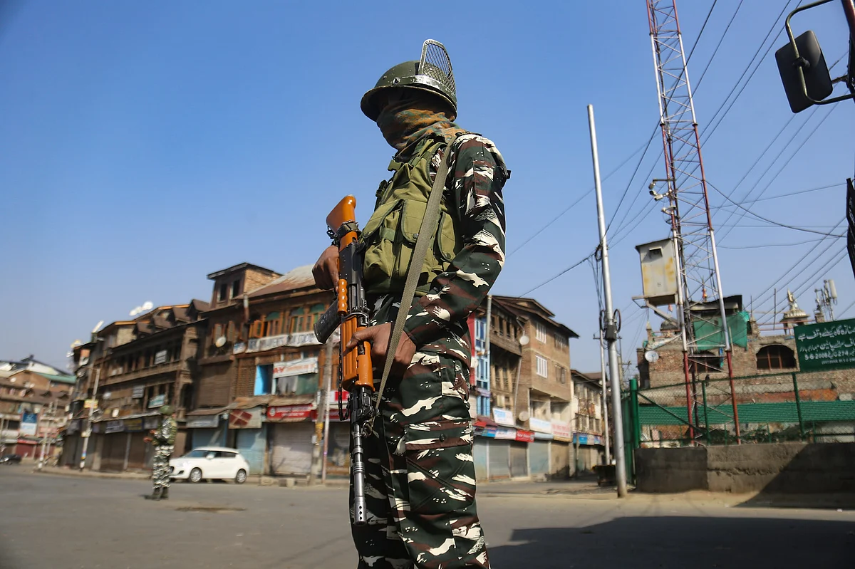 Security personnel stand guard as they block a road during restrictions in Srinagar, Jammu & Kashmir on September 2, 2021.