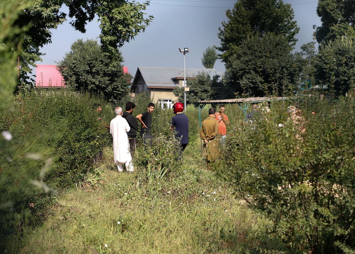 Relatives and neighbours of top separatist leader Syed Ali shah Geeleni gather at his graveyard in Hyderpora, Srinagar, Jammu & Kashmir on September 2, 2021.