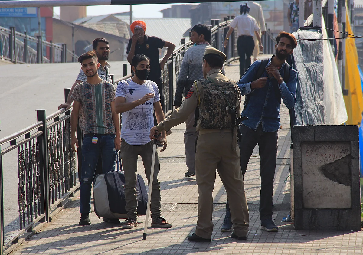 Policeman questions a man on a street during restrictions in Srinagar, Jammu & Kashmir on September 2, 2021.