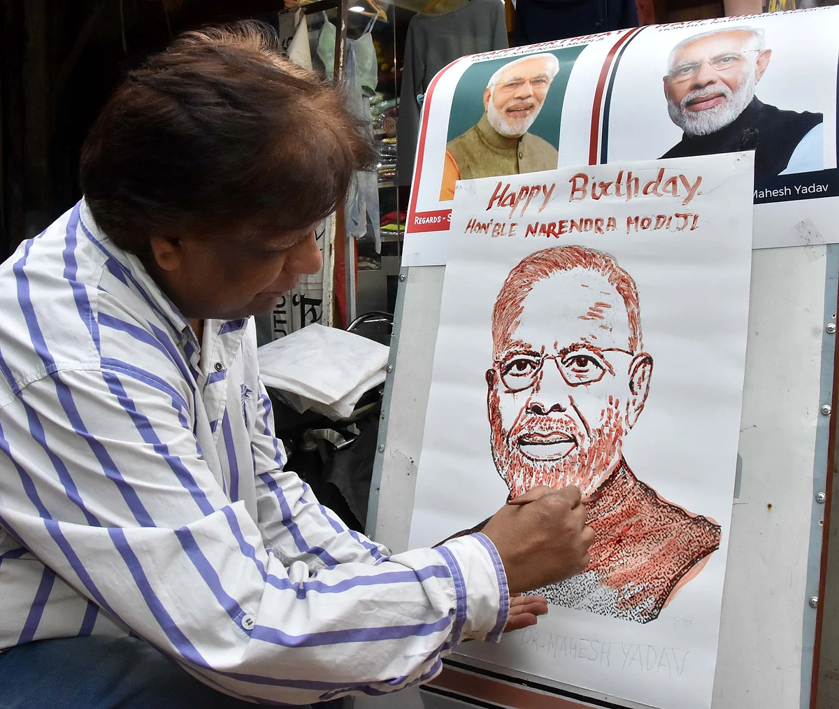 Peace activist Dr Mahesh Yadav sketches portrait of PM Narendra Modi with blood on latter birthday on Friday.