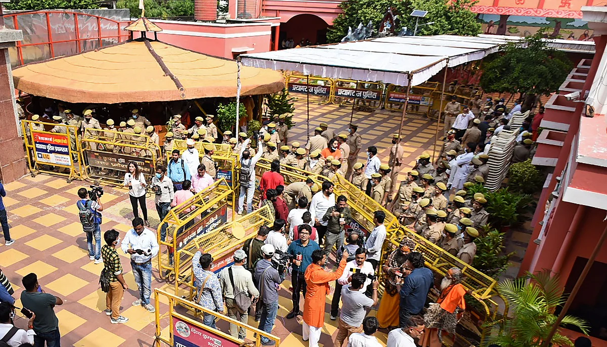 Police personnel and media persons gather at Baghambari Gaddi math as Akhara Parishad President Mahant Narendra Giri Maharaj was found dead, in Prayagraj, Tuesday, Sept. 21, 2021.