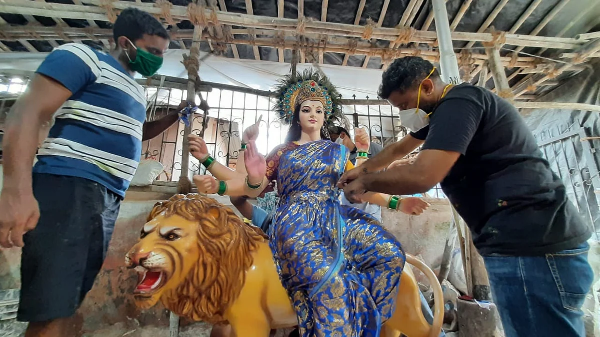 Artists works on an idol of the Hindu goddess Durga at a workshop ahead of the upcoming Navratri festival, in Mumbai on October 5, 2021.