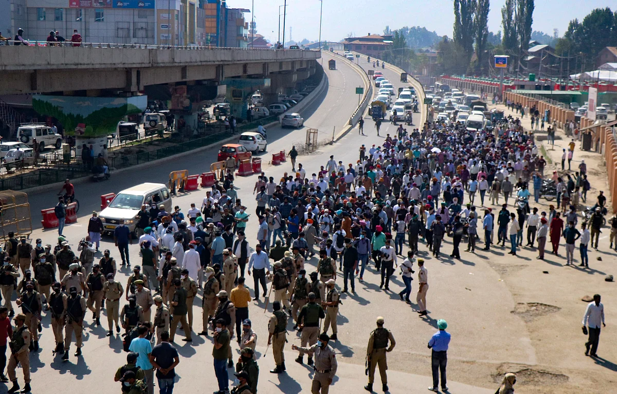 Hundreds of sikh community protesters carry the body of a school principal Supinder Kaur in Srinagar, Kashmir.