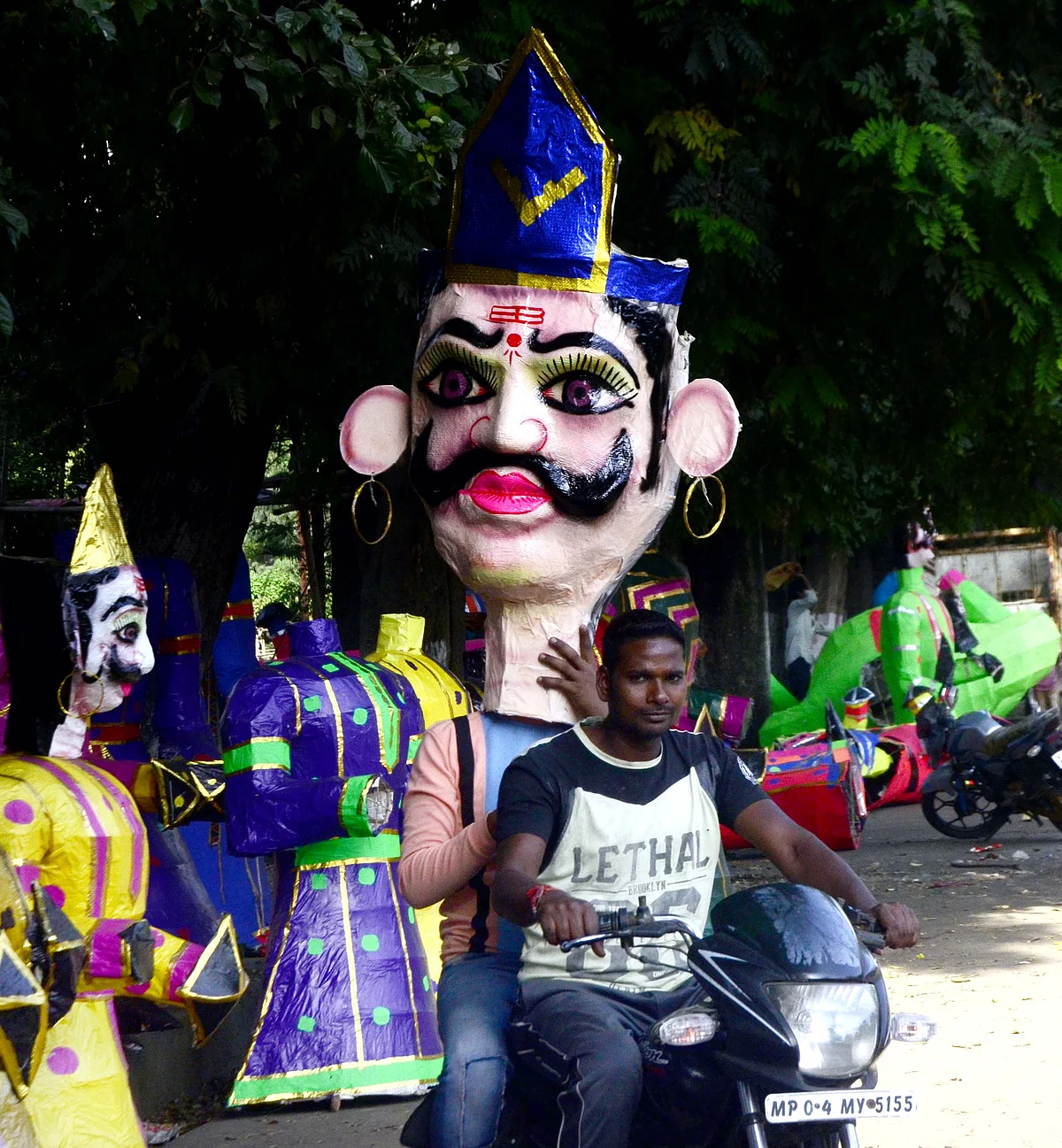 A man carries effigy of Ravana on the eve of Dussehra festival in Bhopal on Thursday
