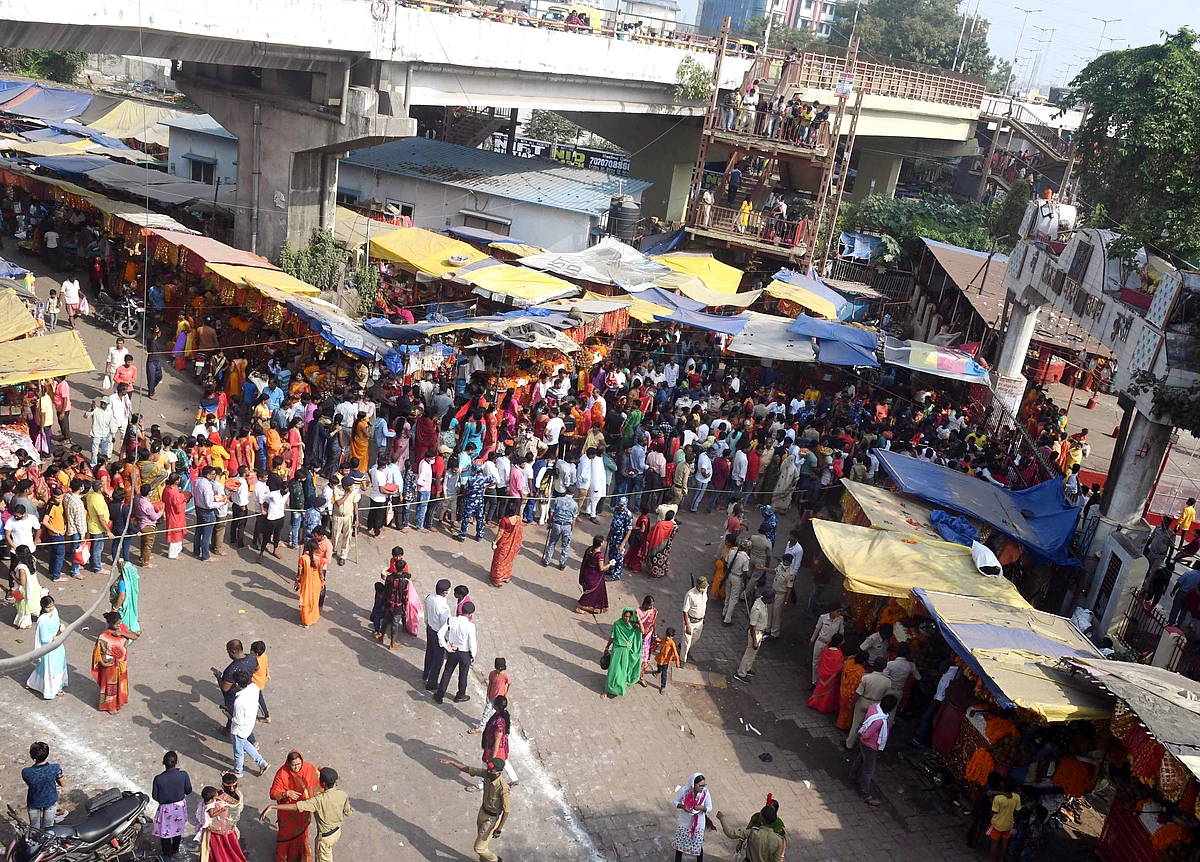 Devotees stand in queues to offer prayers outside the temple on the occasion of Navami of Navratri festival at Agam Kuan, in Patna on Thursday.