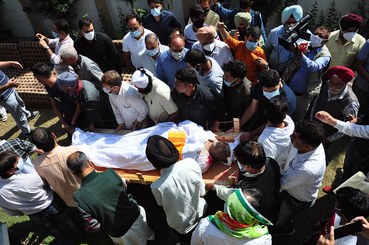 Relatives and neighbors carry the body of prominent pharmacist Makhan Lal Bindroo during his funeral at his residence in Srinagar,Kashmir. Bindroo, a Kashmiri Hindu and two other civilliana were killed by Suspected militants in separate attacks on last evening.