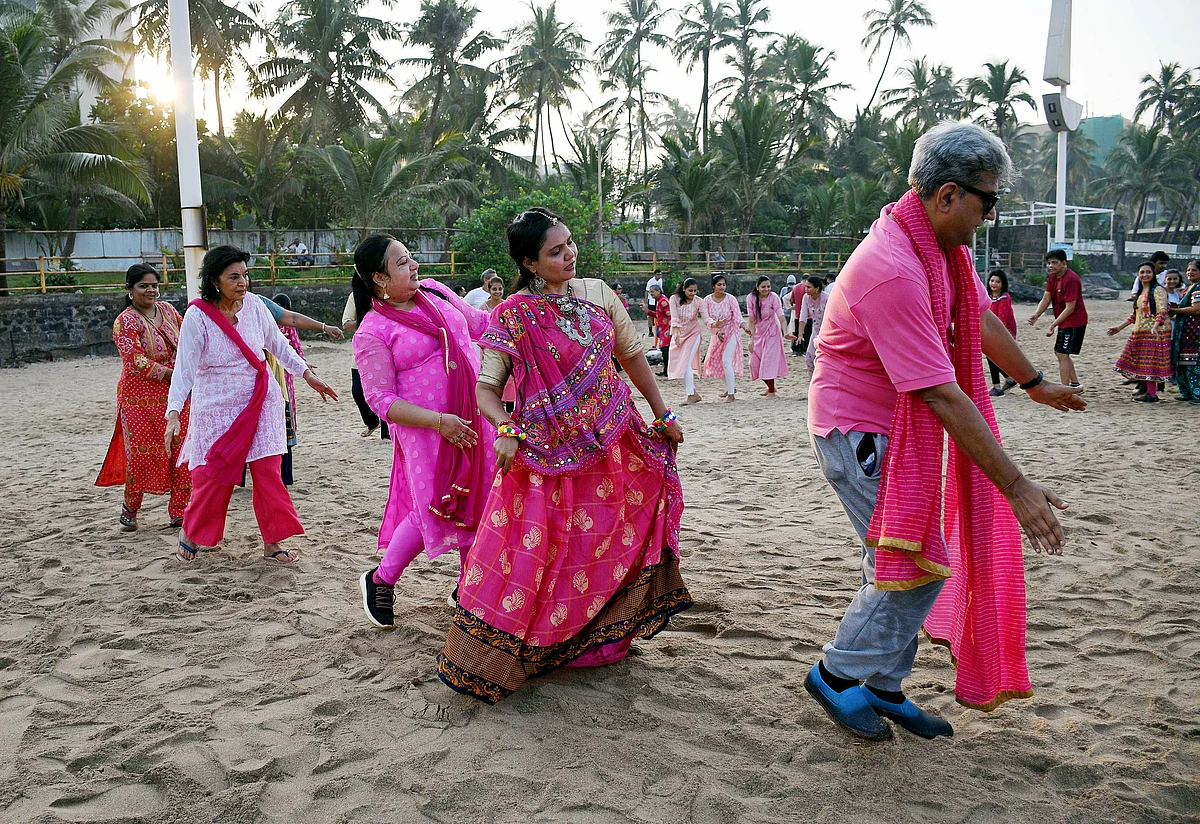 People perform Garba dance at Juhu Beach on the occasion of the Navami of Navratri festival, in Mumbai on Thursday.