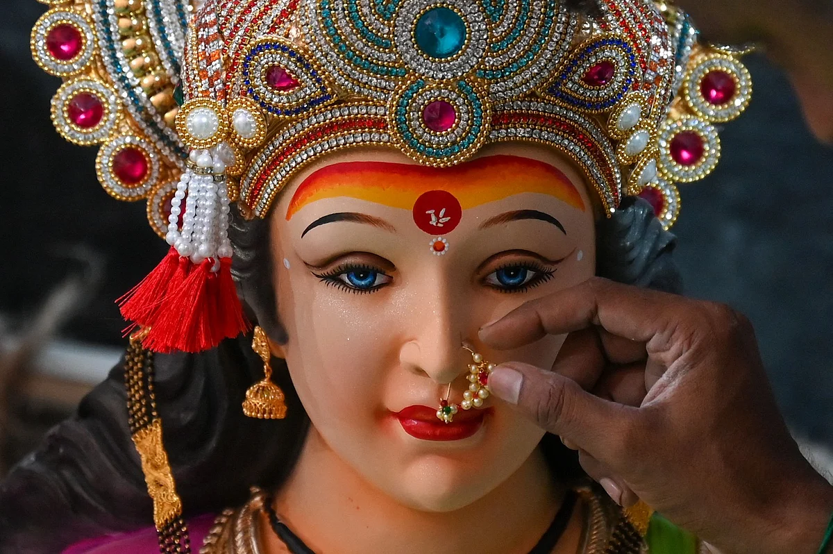 An artisan works on an idol of the Hindu goddess Durga at a workshop ahead of the upcoming Navratri festival, in Mumbai on October 5, 2021.