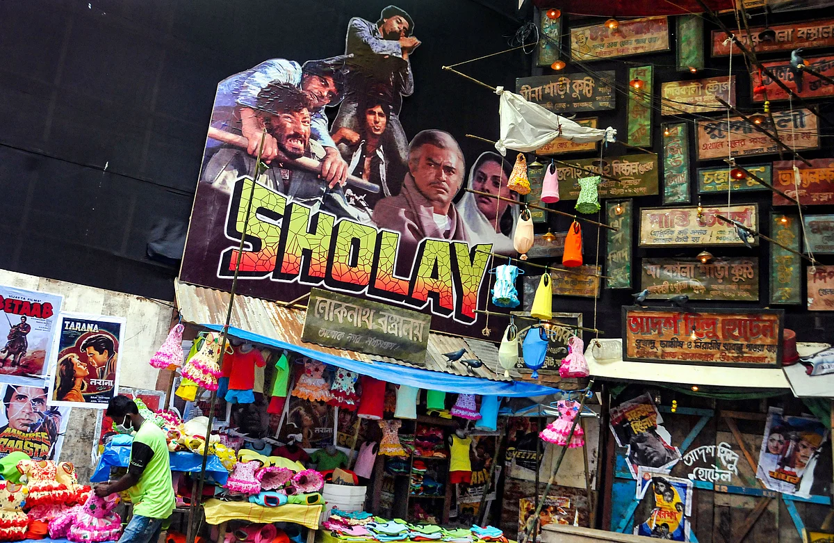 A poster of Sholay film put up inside the puja pandal ahead of Durga Puja festival in Kolkata, Wednesday, Oct. 6, 2021.