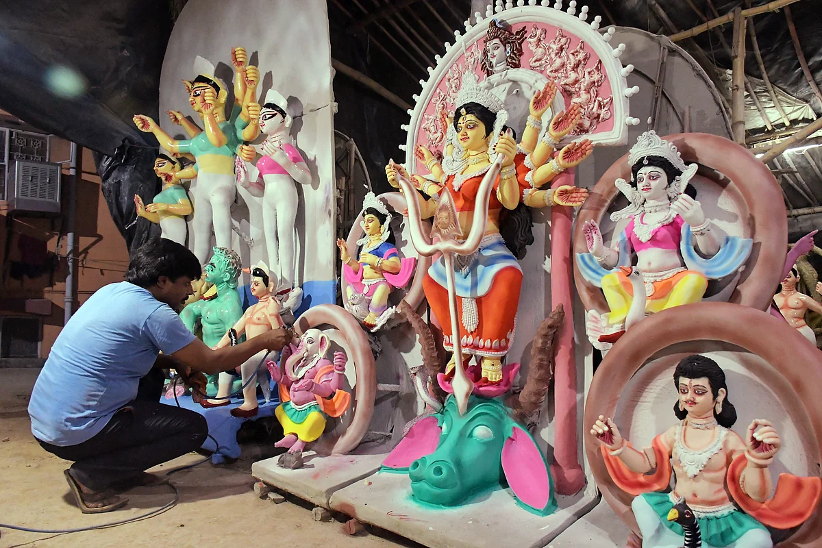 An artist gives final touches to an idol of Goddess Durga for the upcoming Durga Puja festival, at Chittaranjan Park, in New Delhi on Tuesday.