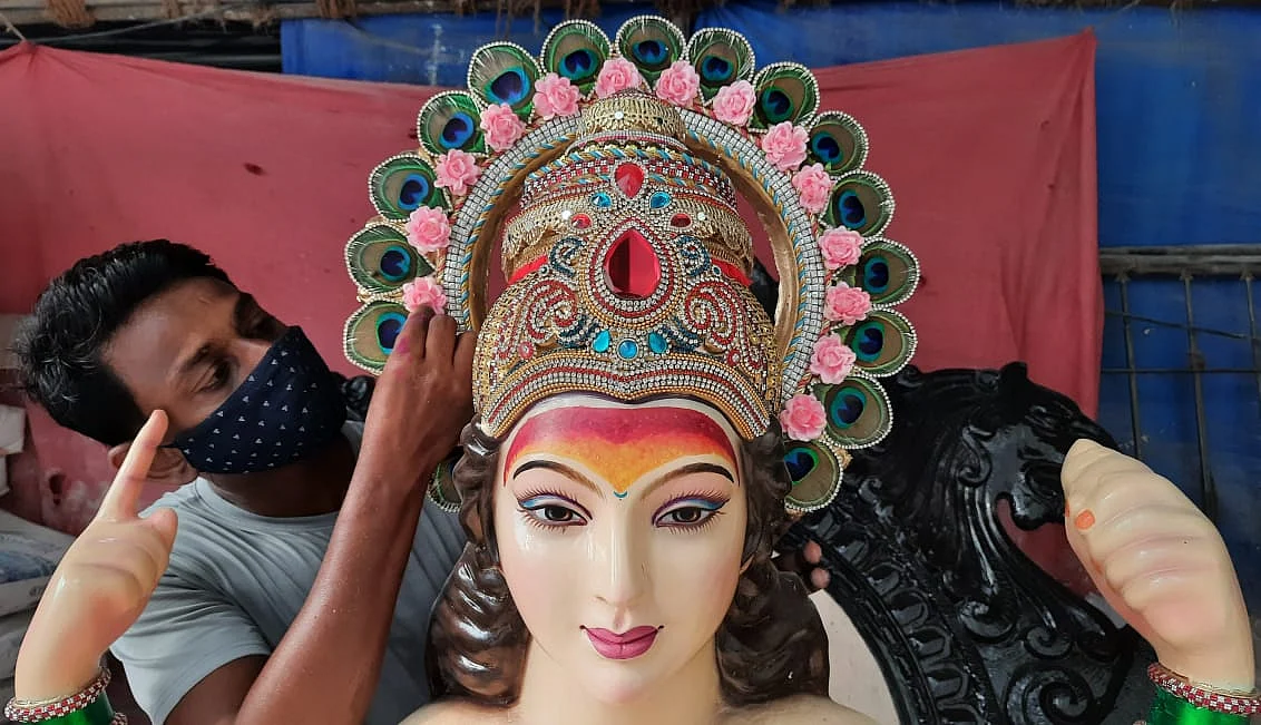 An artisan works on an idol of the Hindu goddess Durga at a workshop ahead of the upcoming Navratri festival, in Mumbai on October 5, 2021.