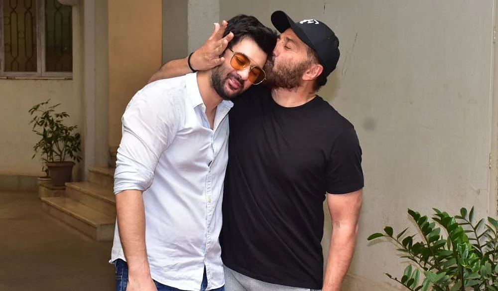 In Pics: Doting dad Sunny Deol kisses son Karan on the forehead as latter cuts birthday cake with...