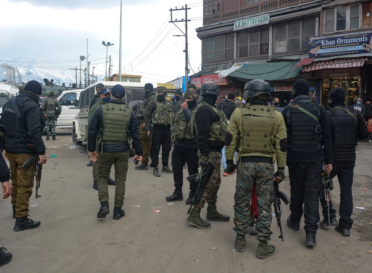 Policemen patrol after a grenade attack by Suspected Militants in Srinagar.