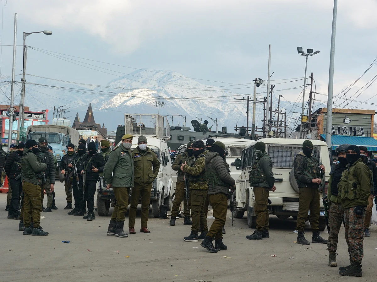 Policemen patrol after a grenade attack by Suspected Militants in Srinagar.