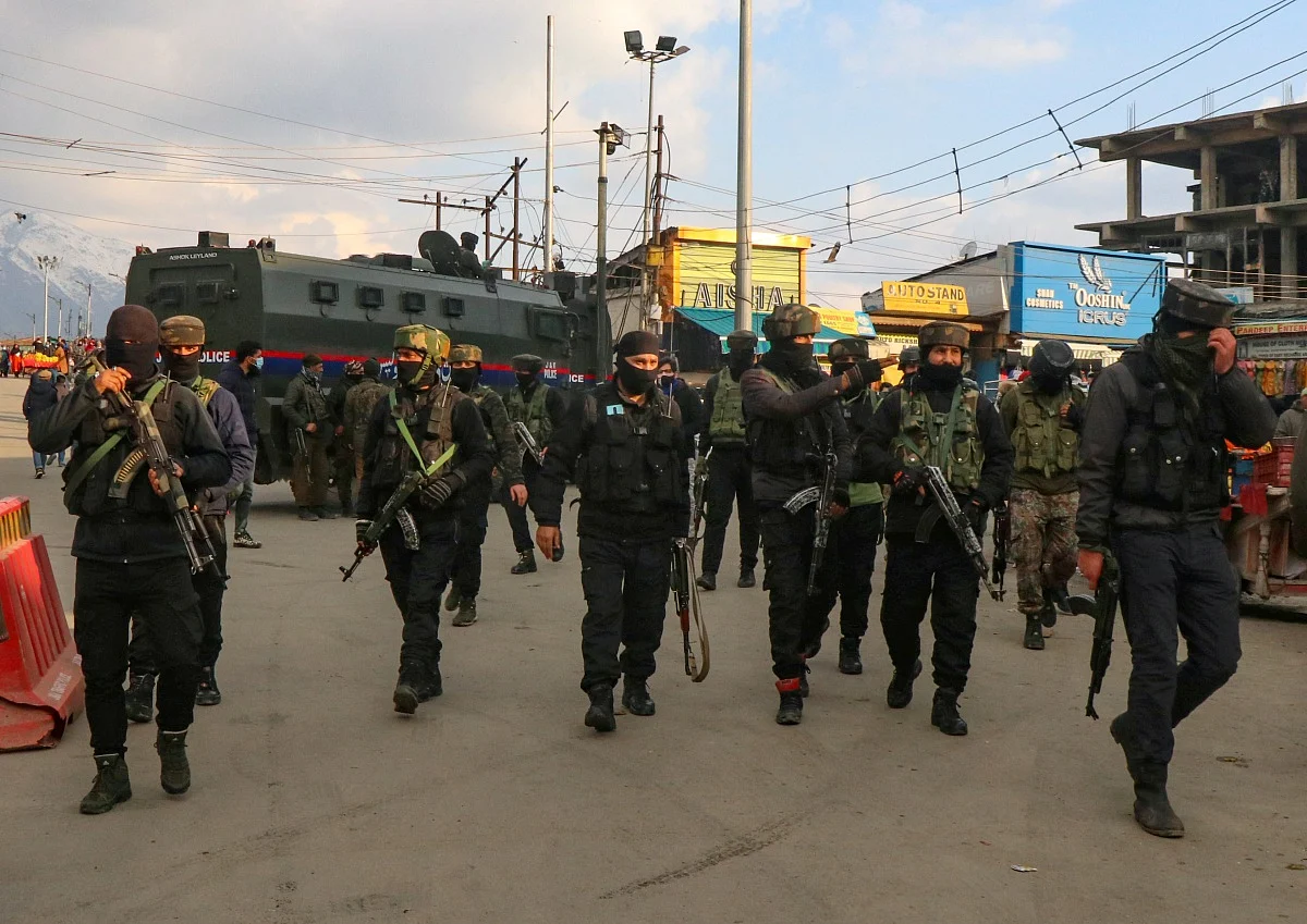 Policemen patrol after a grenade attack by Suspected Militants in Srinagar.