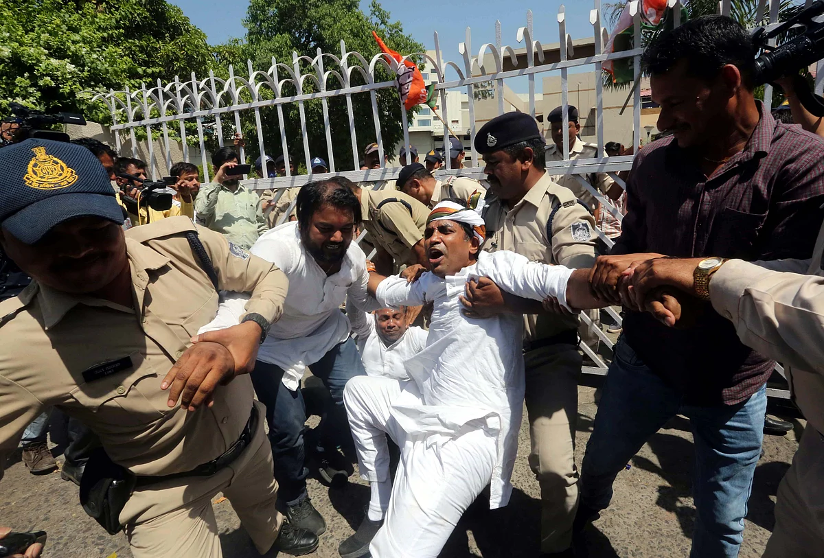 Police personnel detain Madhya Pradesh Youth Congress workers during their protest over alleged corruption in the Teacher Eligibility Test (TET) conducted by Vyapam, in front of the office of the Professional Examination Board, in Bhopal, Thursday,