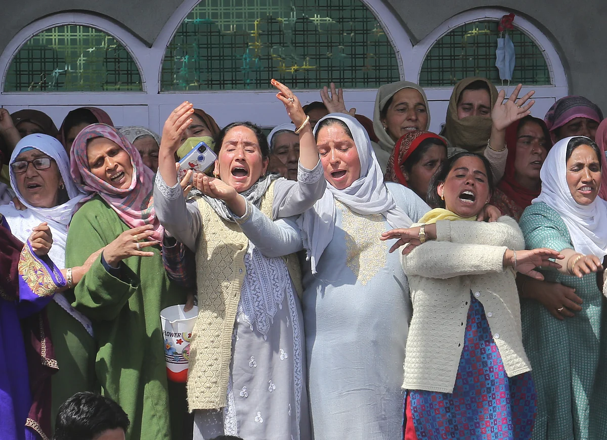 Relatives mourn at the funeral of slain policeman and his brother at Chattabugh village of central Kashmir's Budgam district