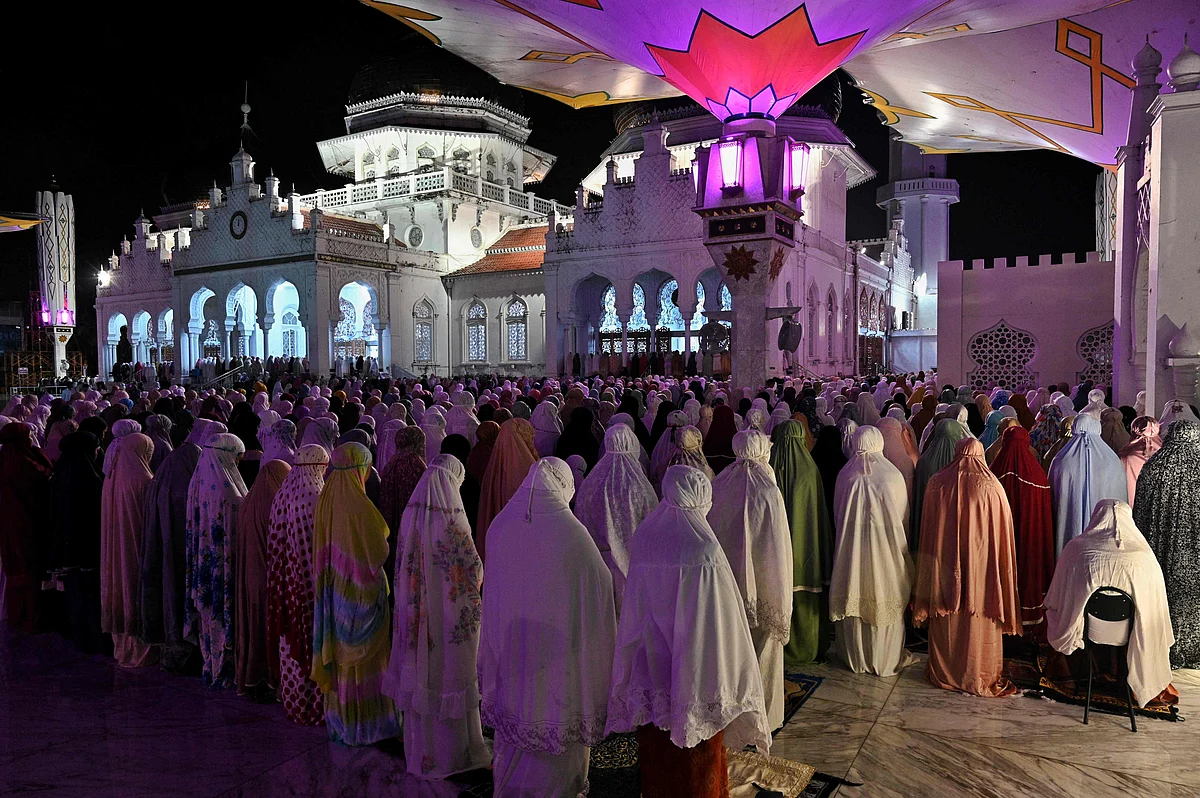Muslim worshippers perform the first evening Tarawih prayer on the first night of the holy fasting month of Ramadan, at the Baiturrahman grand mosque in Banda Aceh on April 2, 2022. (Photo by CHAIDEER MAHYUDDIN / AFP)