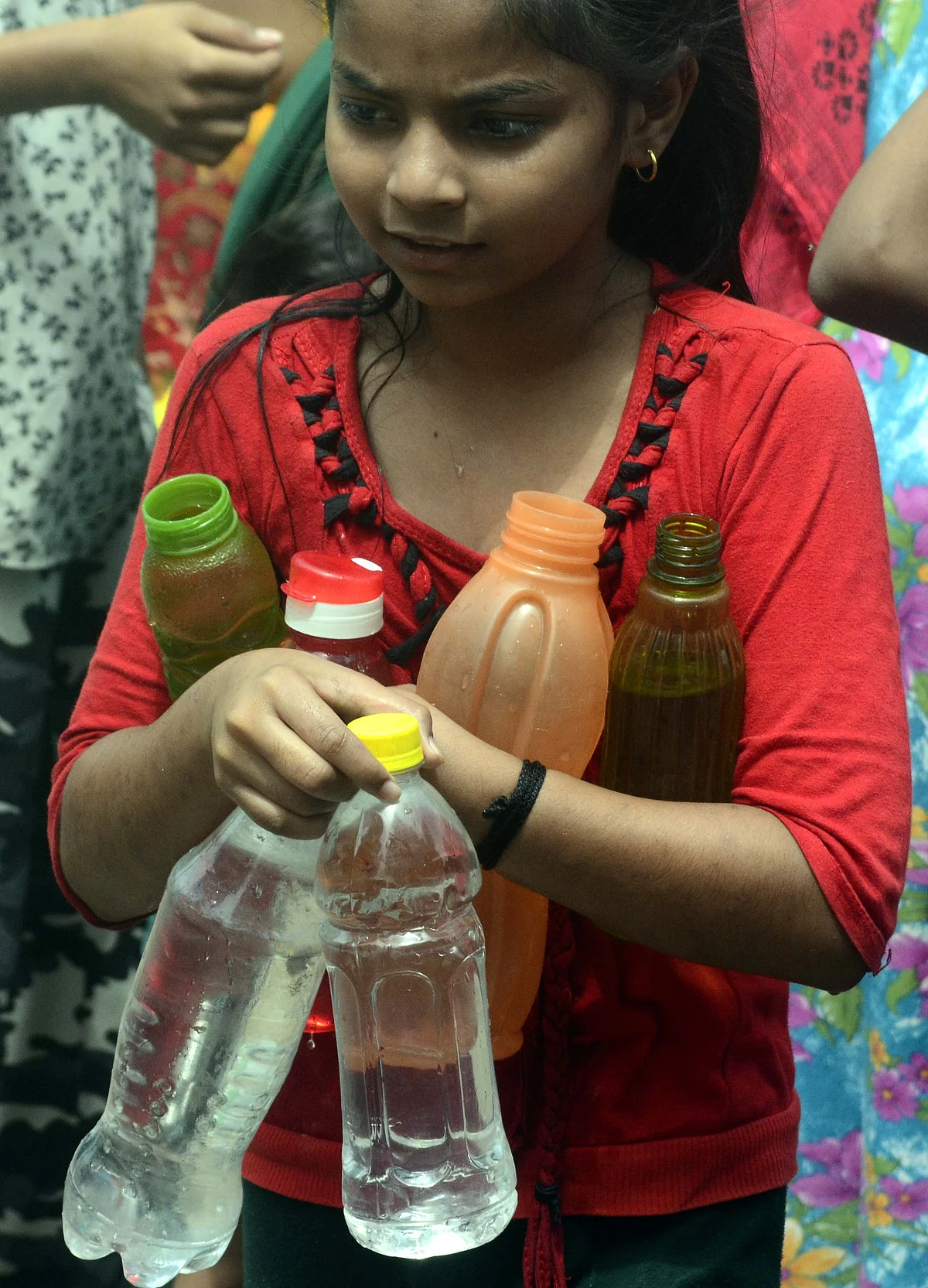 A girl standing for her turn to get her bottles filled as water supply remained disrupted in many parts of Bhopal for the fourth consecutive day on Sunday due to laying of new Kolar pipeline.