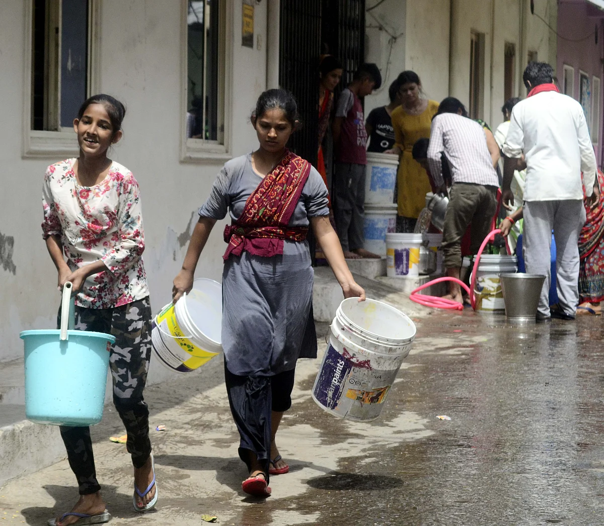 People crowding to fill their vessels from tanker as water supply remained disrupted in many parts of Bhopal for the fourth consecutive day on Sunday due to laying of new Kolar pipeline.