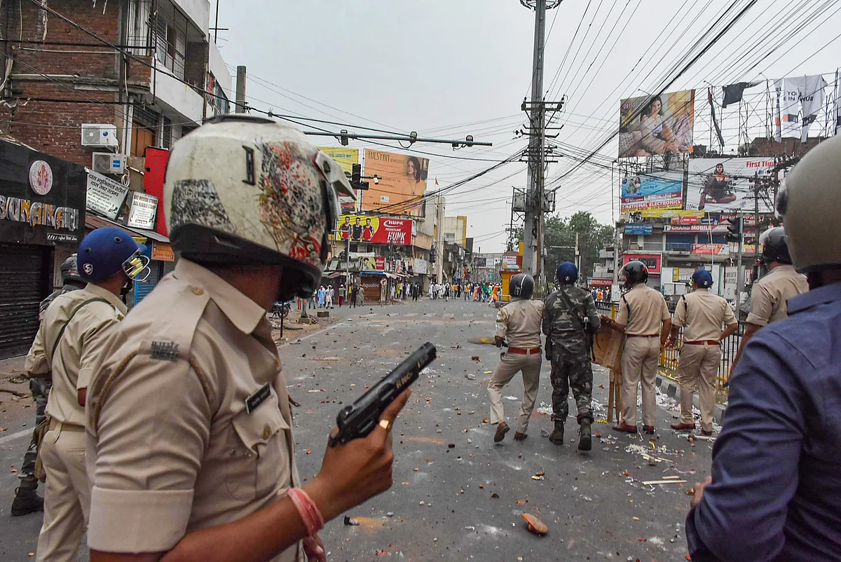 Ranchi: Security personnel chase away people protesting over controversial remarks made by two now-suspended BJP leaders about Prophet Mohammad, in Ranchi, Friday, June 10, 2022.