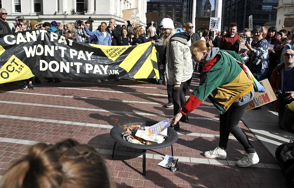 Protesters burn symbolic energy bills outside the ICC in Birmingham prior to the Conservative Party conference at the ICC, Birmingham, England, on October 1