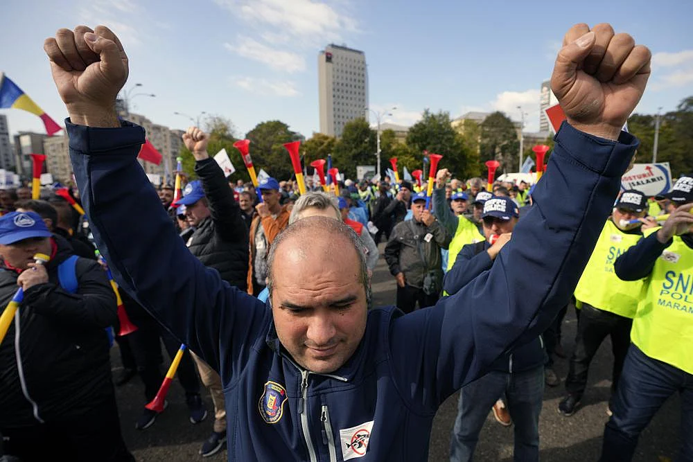 A man clenches his fists during a protest outside the government headquarters in Bucharest, Romania, on October 20