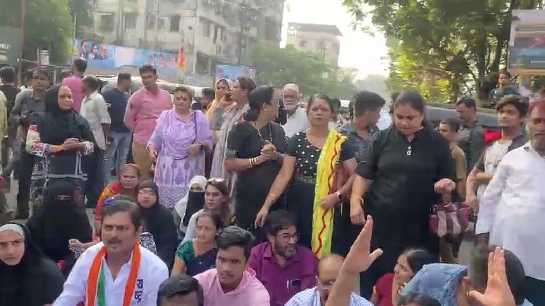 NCP party workers protest outside Mumbra police station against  molestation charges on Jitendra Awhad - Vimarsana News