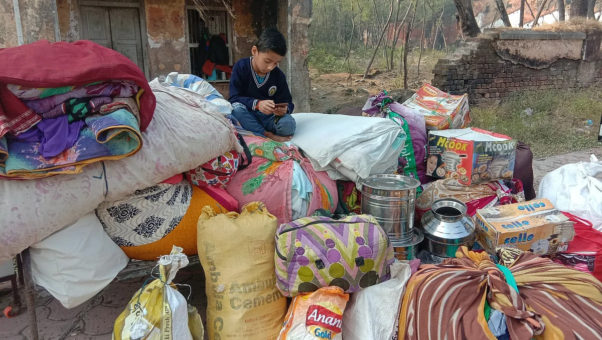 A boy sitting with household items during the pack-up exercise
