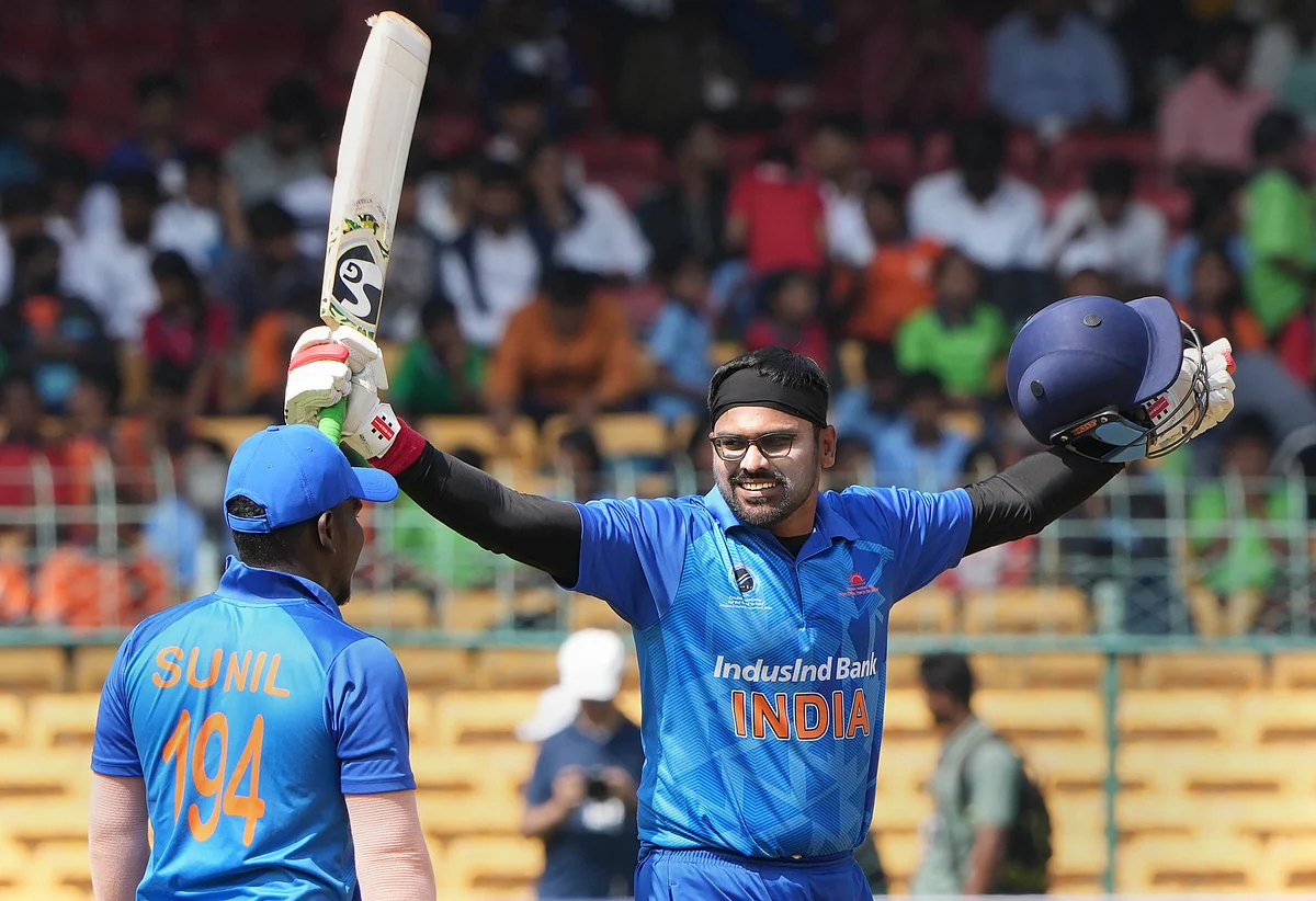 India's Ajay Reddy celebrates his century with teammate Sunil Ramesh