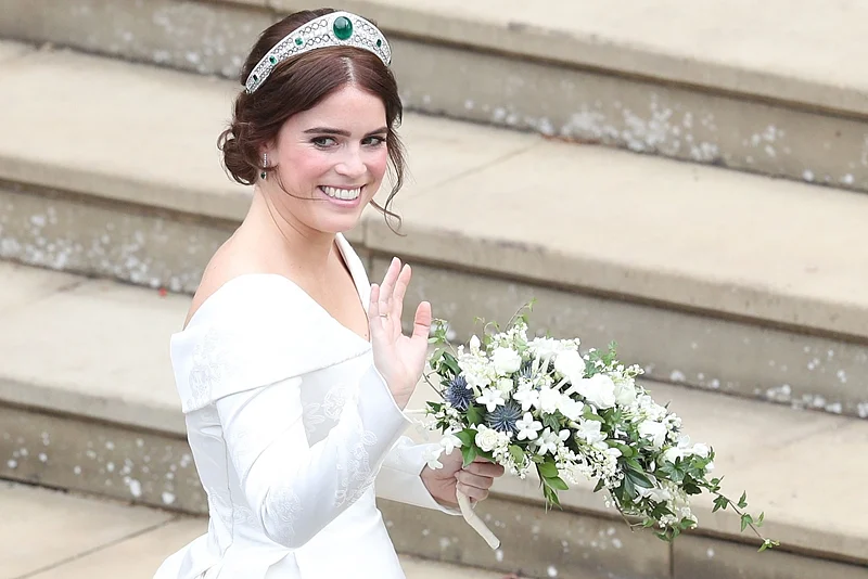 Britain’s Princess Eugenie of York waves as she arrives for her wedding to Jack Brooksbank at St George’s Chapel, Windsor. Photo by Andrew Matthews / POOL / AFP