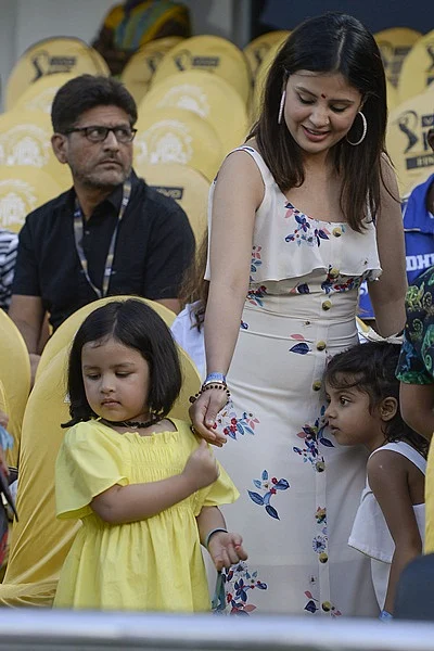 Chennai Super Kings cricket team captain Mahendra Singh Dhoni’s wife Sakshi Dhoni (C) along with her daughter Ziba (L) gesture before the start of the 2019 Indian Premier League (IPL) Twenty20 final cricket match between Mumbai Indians and Chennai Super Kings at the Rajiv Gandhi International Cricket Stadium in Hyderabad on May 12, 2019. (Photo by NOAH SEELAM / AFP)