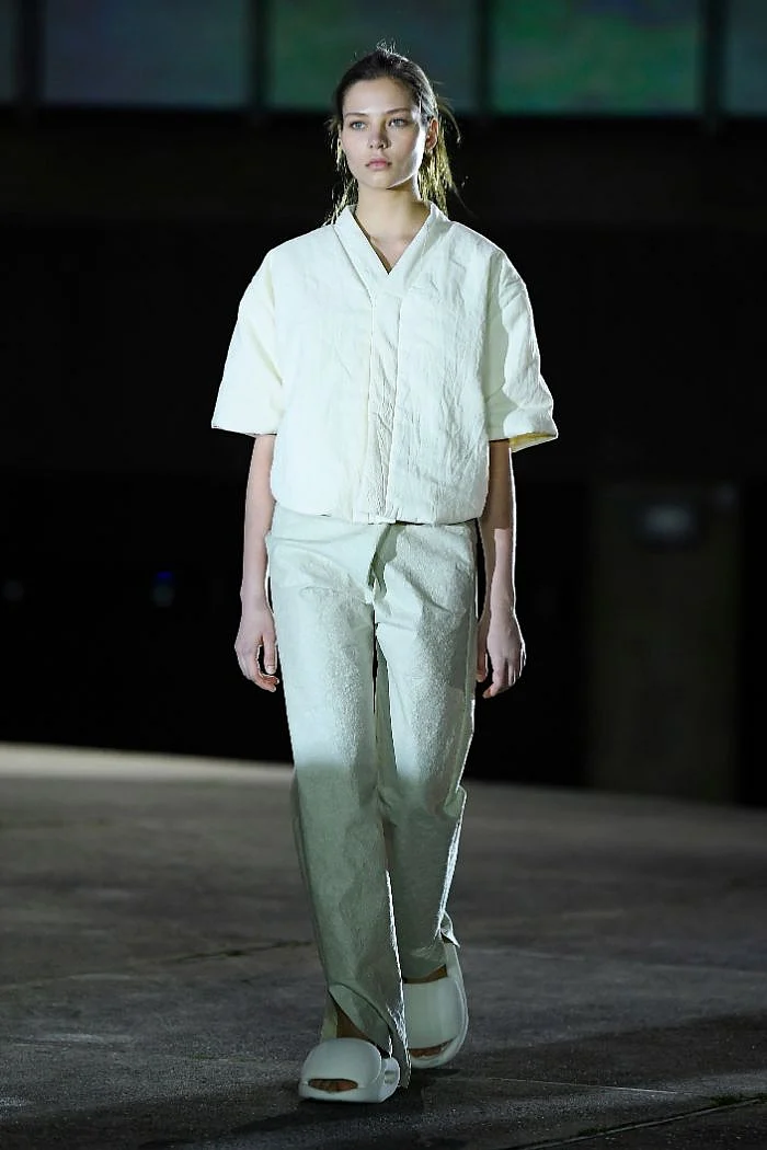 Model sporting Yeezy slides at Paris Fashion Week