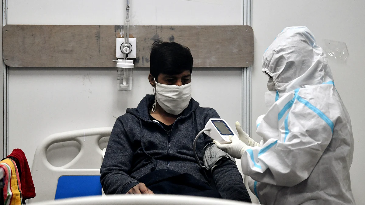 Healthcare worker check pulse rate and oxygen level of Covid patient,