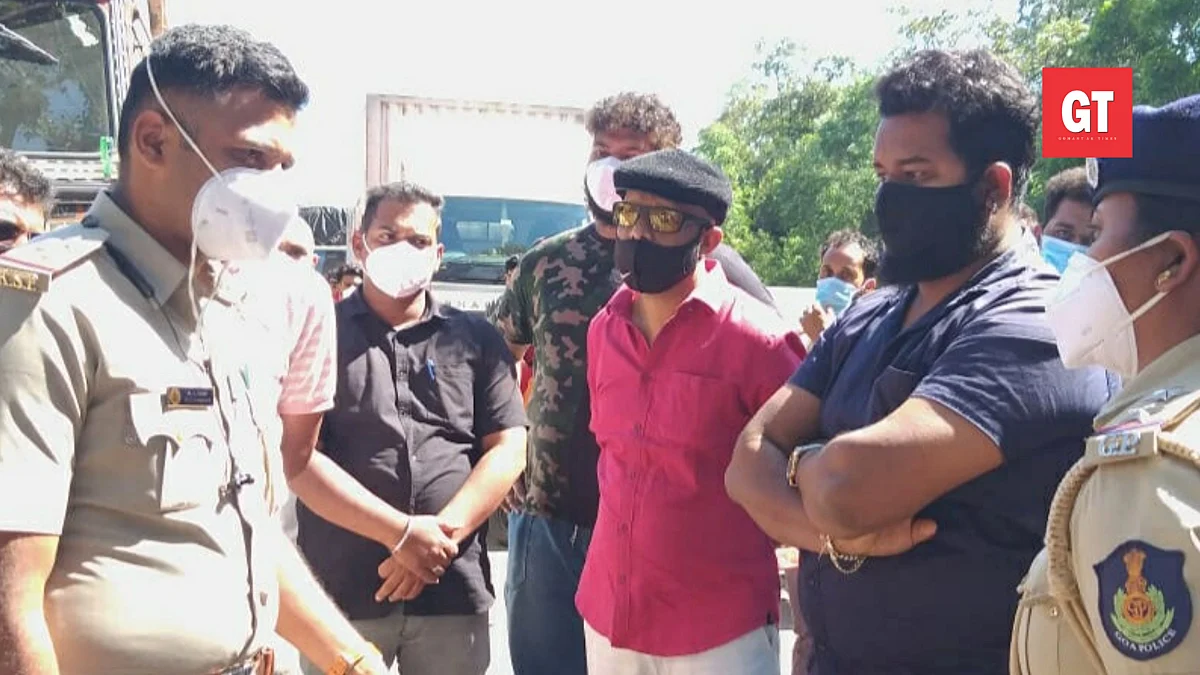 Congress general secretary Janardhan Bhandari stop vehicles at the Polem checkpost