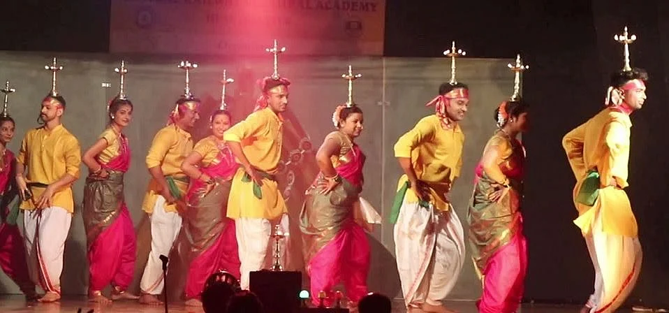 <div class="paragraphs"><p>The <em>Samayi</em> dance, involves a balancing act using lighted brass lamps</p></div>