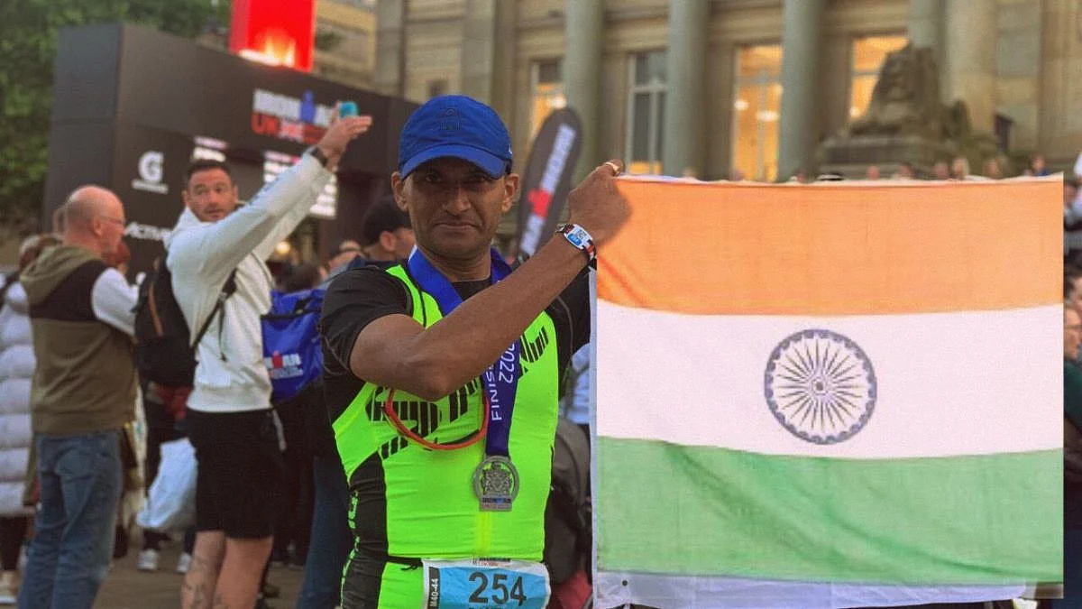 Santosh Shanbhag proudly displays the Indian flag after finishing the Bolton Ironman.