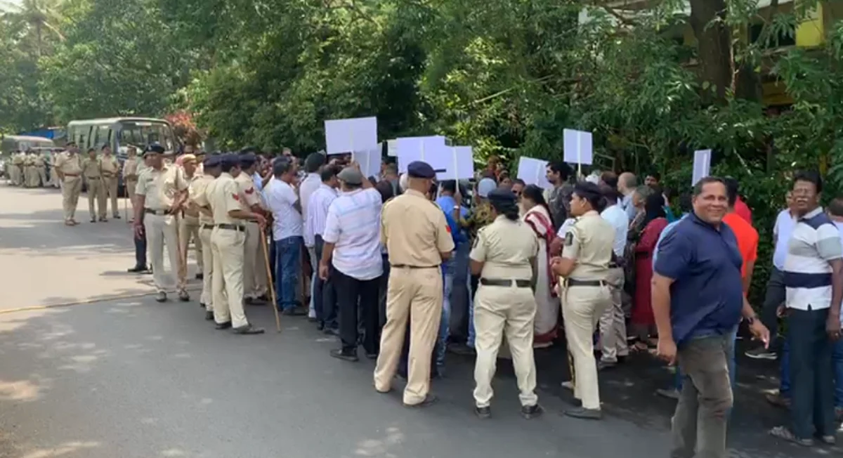Protestors and police force are seen outside the house of Nuvem MLA in Raia on Wednesday.