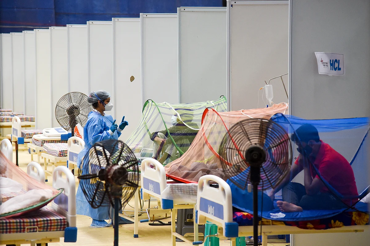A healthcare worker in PPE kit interacts with COVID-19 patients at CWG COVID care center, in New Delhi on Tuesday, 29 June 2021.