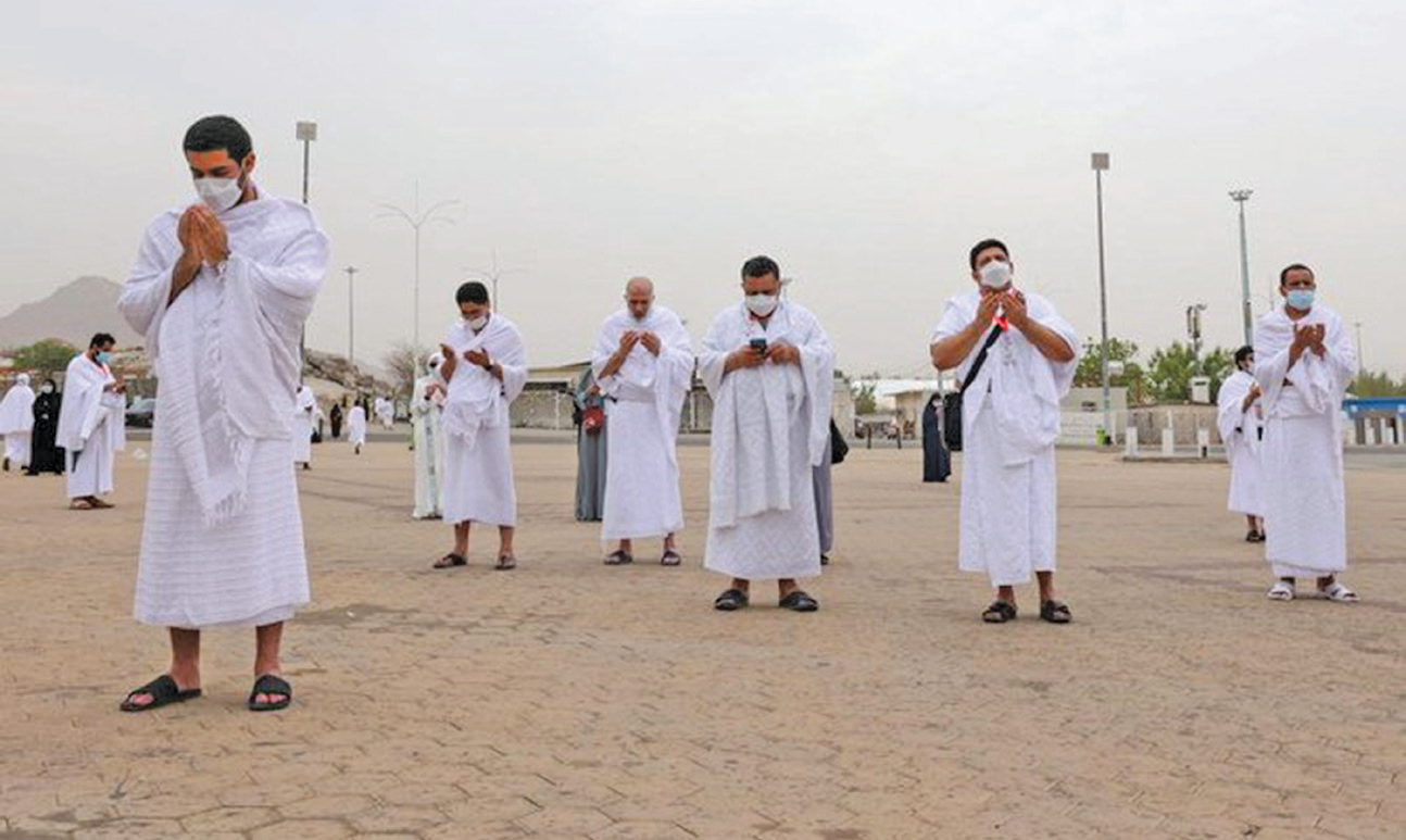 Masked Hajj pilgrims on Mount Arafat pray for COVID-free world