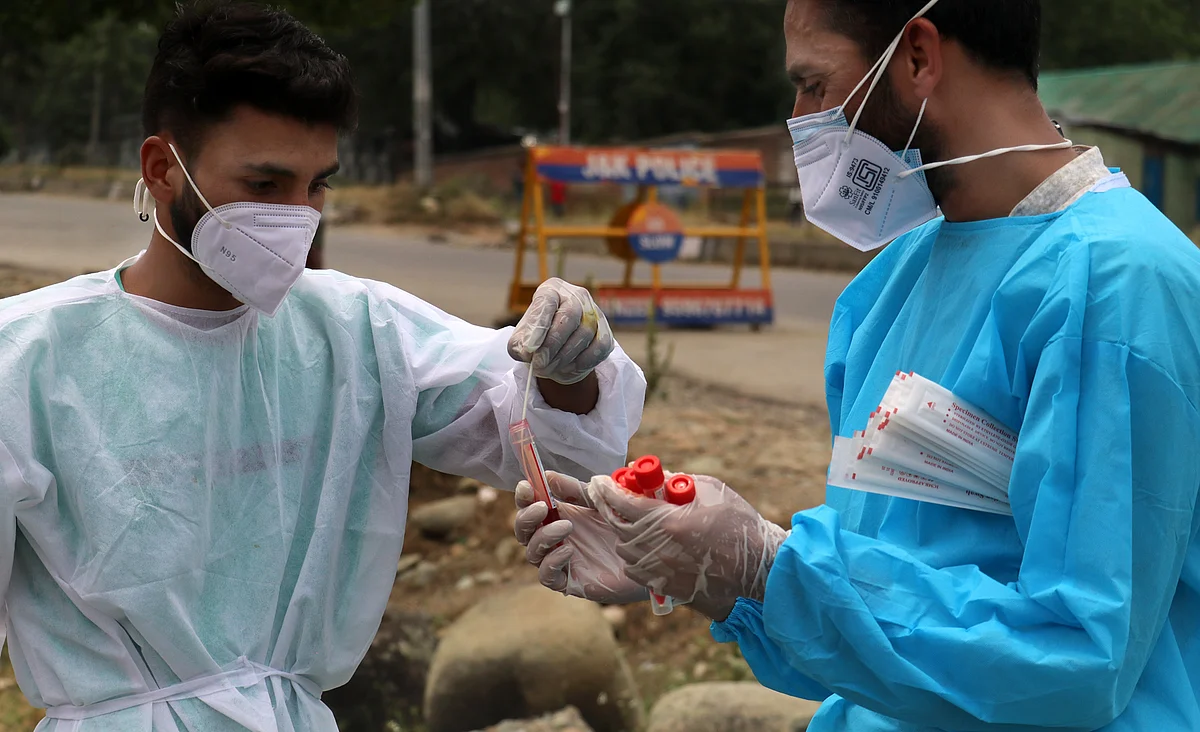Health workers sort a swab sample for COVID-19 testing taken from a tourist on way to Gulmarg in north Kashmir's Baramulla district.