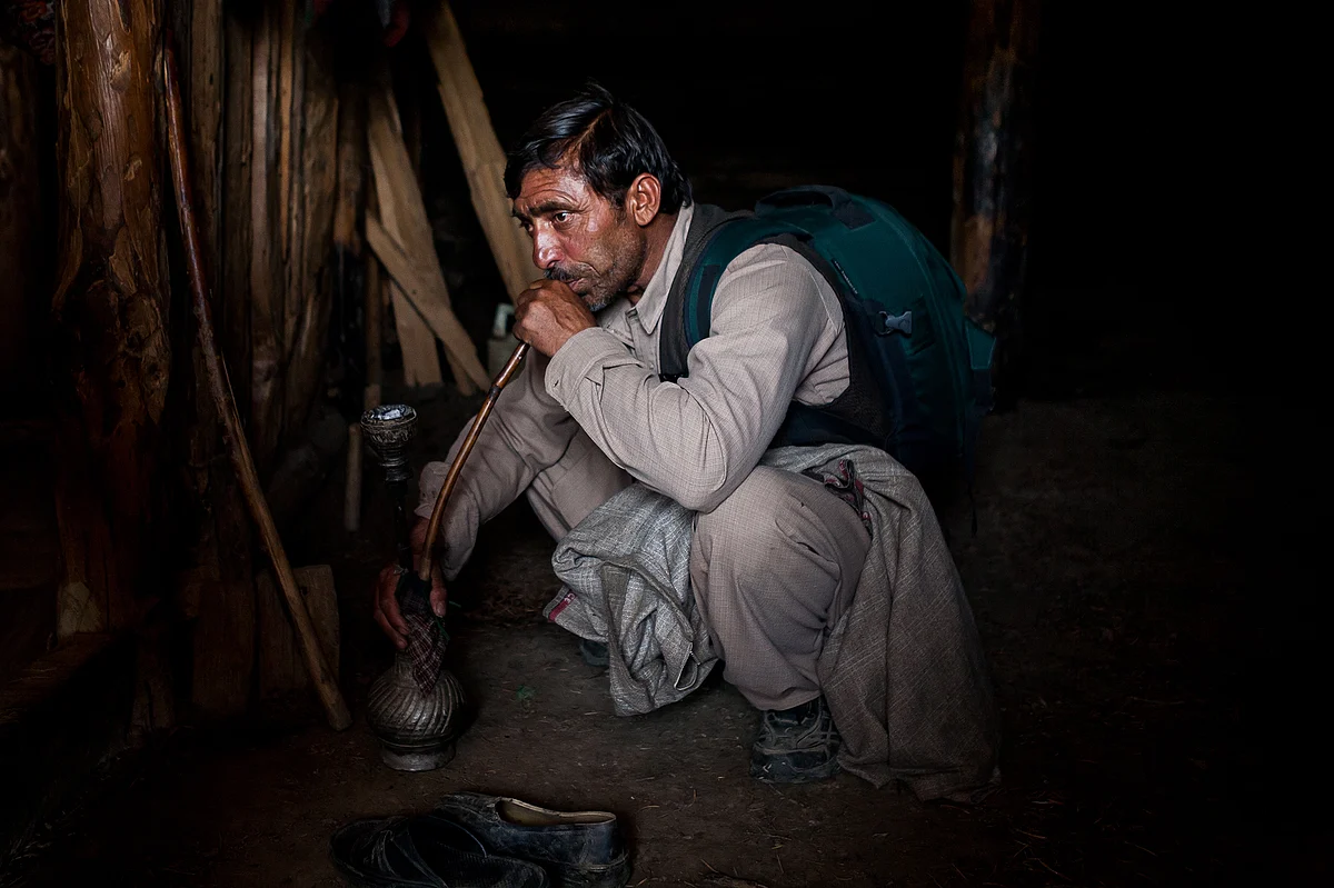 A man smokes traditional Kashmiri hookah.