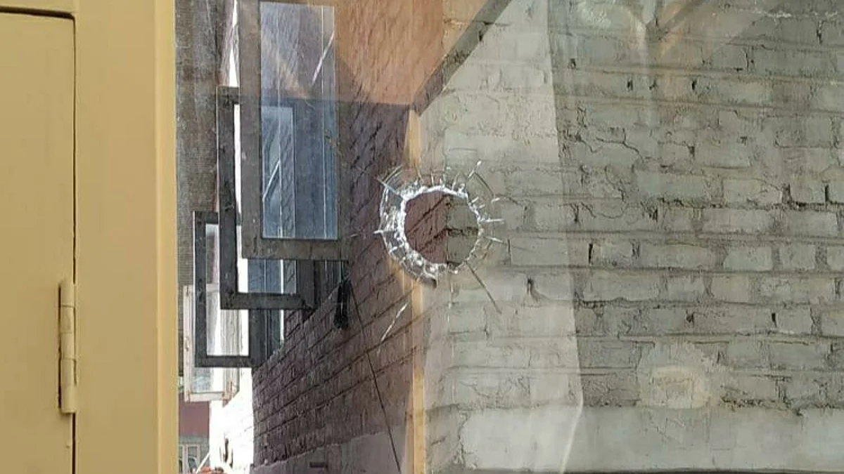 A hole in a glass windowpane of a residential house pierced by an alleged stray bullet during a shootout the preceding night between militants and police, in Tulsibagh area of Srinagar on Saturday October 9, 2021.