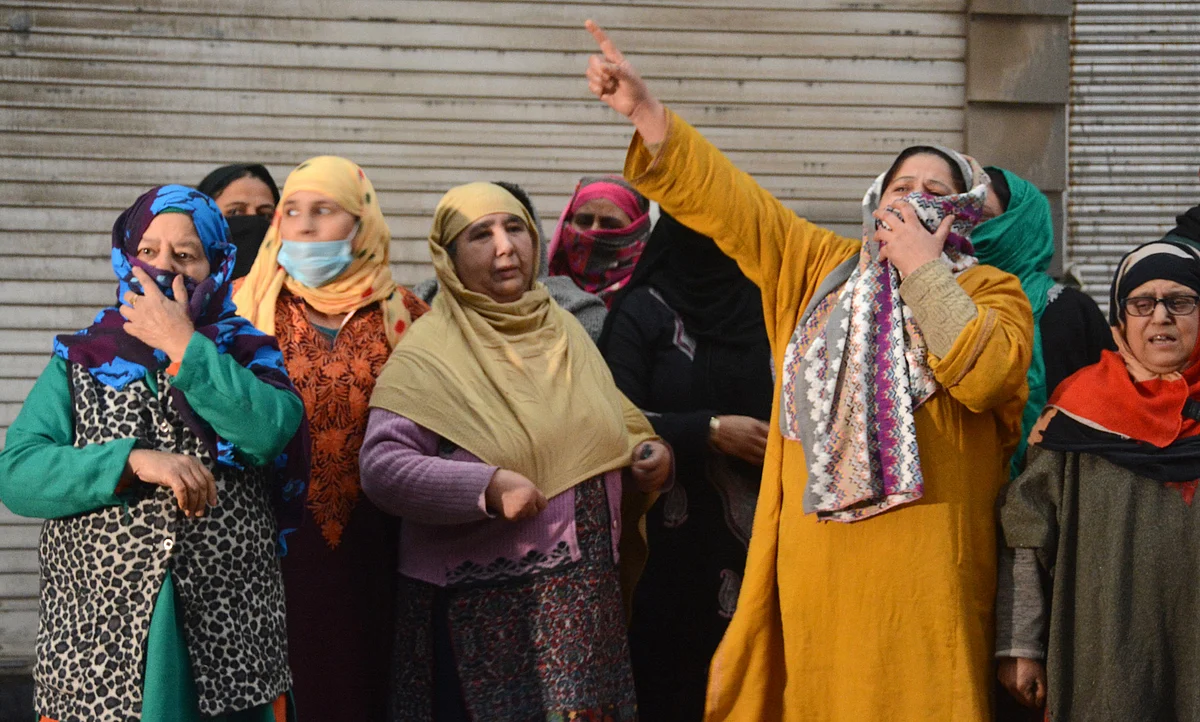 Women are seen wailing near the shootout site, on Wednesday 24 Nov 2021.