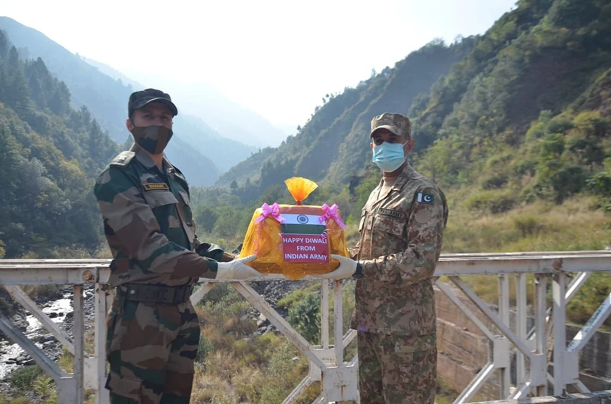 The personnel of Indian and Pakistani army exchange sweets on the occasion of Diwali.