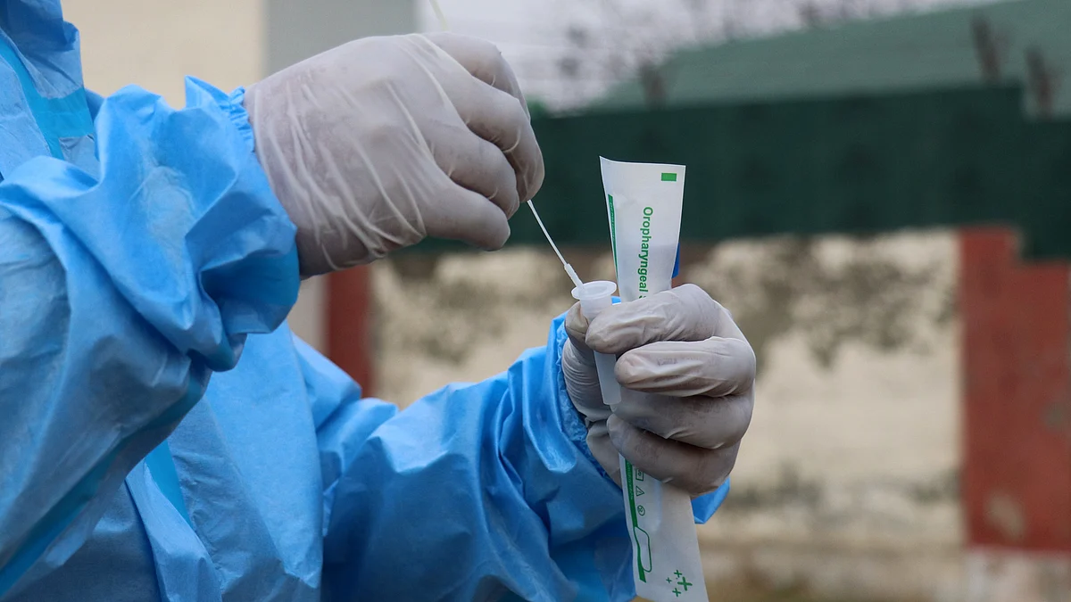 A health workers collects swab sample for COVID-19 testing taken from a tourist at Tangmarg on way to tourist resort Gulmarg in north Kashmir's Baramulla district.